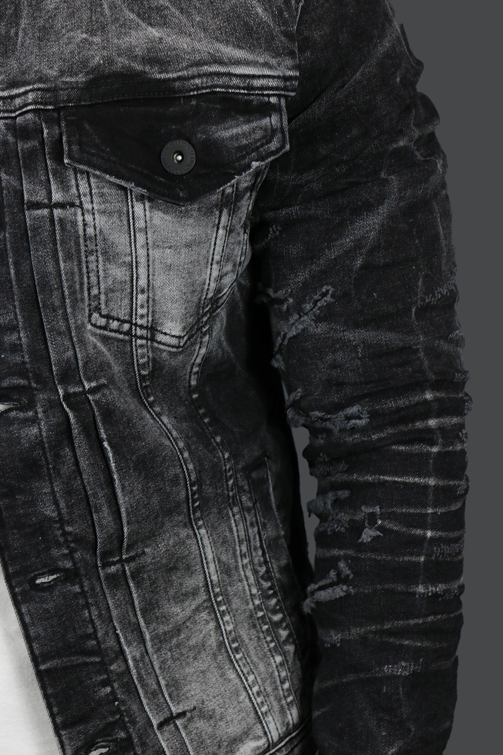 The wearer's left on the Industrial Black Distressed Denim Jacket | Jordan Craig