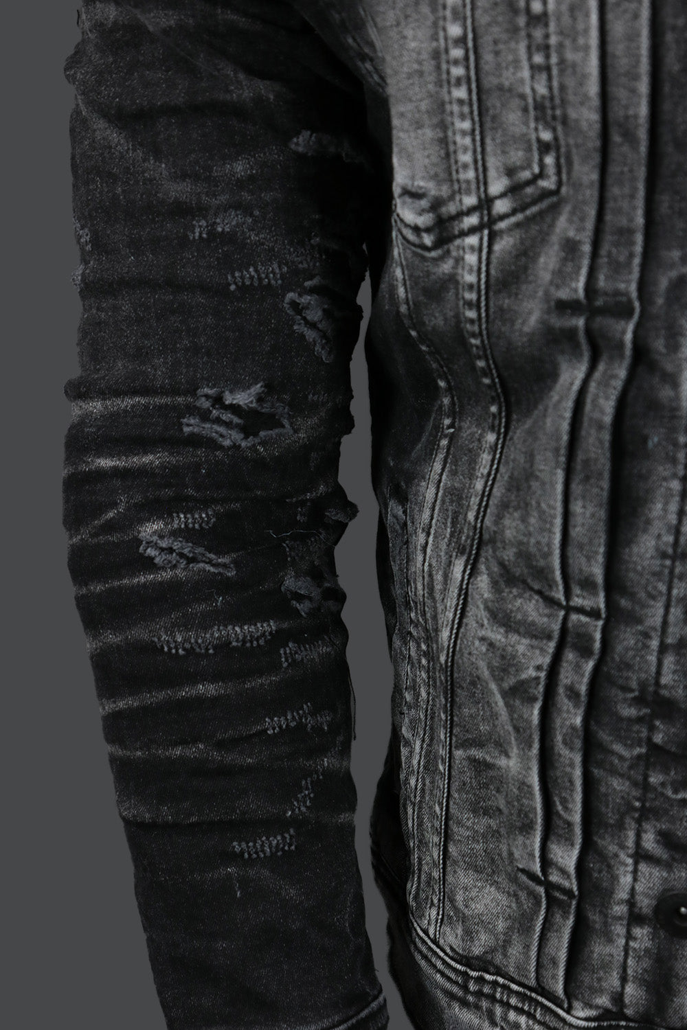 A close up of the wearer's right on the Industrial Black Distressed Denim Jacket | Jordan Craig