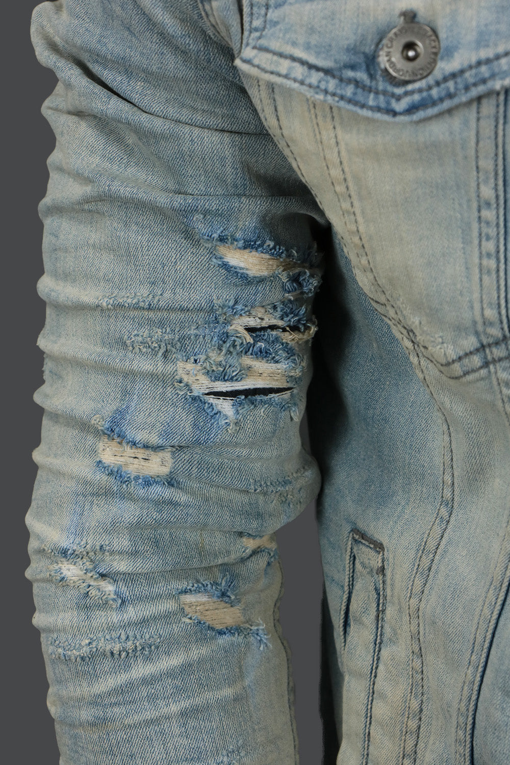 A close up of the ripped arms on the Iced Lager Distressed Denim Jacket | Jordan Craig