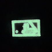 MLB logo glowing in the dark on the Atlanta Braves Glow In The Dark 1995 World Series Peach Bottom 59Fifty Side Patch Fitted Cap