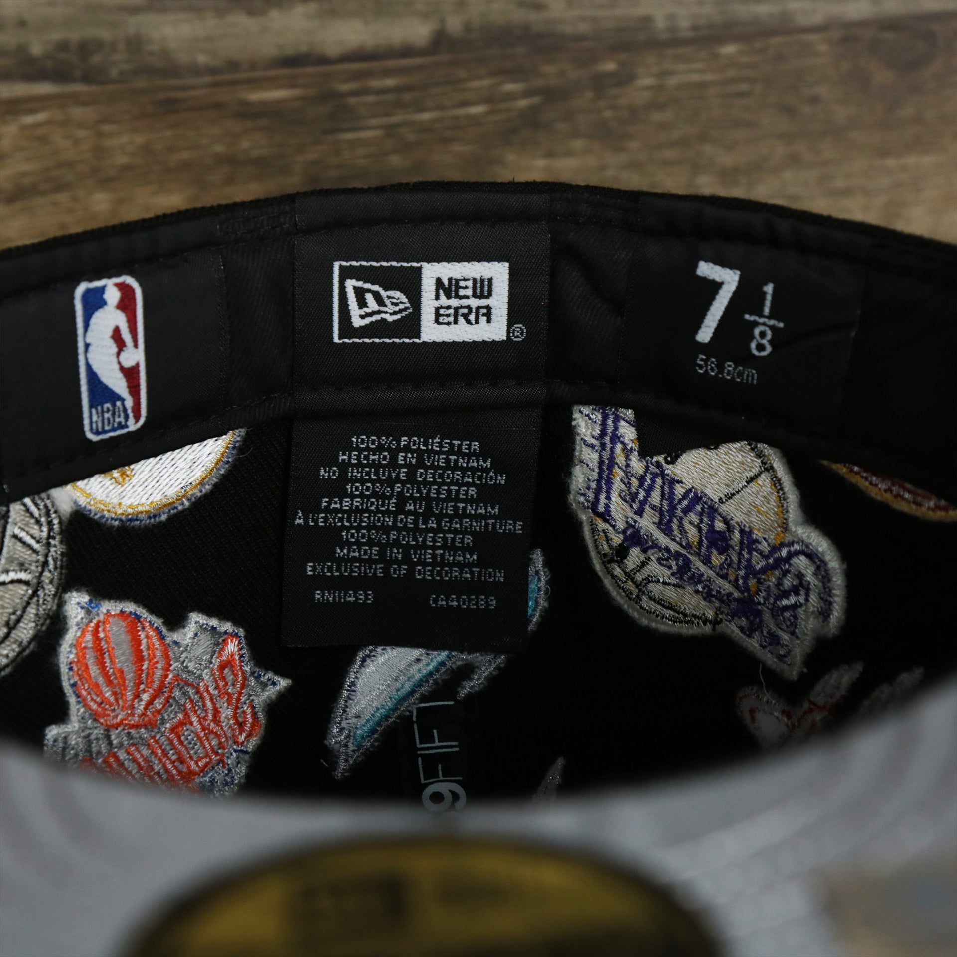 The NBA Tags and New Era Tags on the NBA Logo All Over patch fitted 59Fifty Cap with Gray Bottom | Black