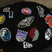 The New Era logo and NBA Teams' logos on the NBA Logo All Over patch fitted 59Fifty Cap with Gray Bottom | Black