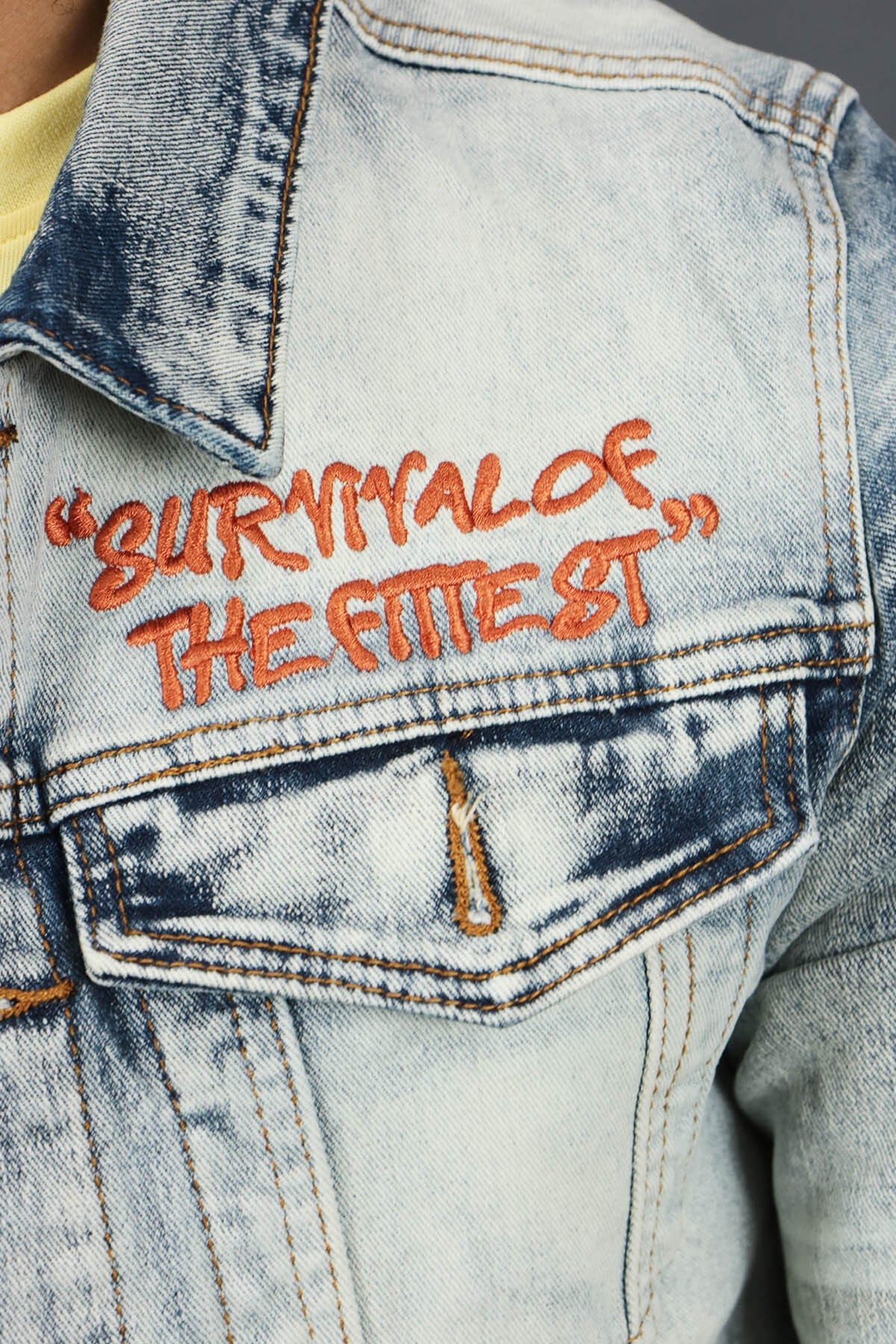 A close up of the Chest Embroidery on the Only The Strong Custom Spray Painted Denim Jacket Motive Denim | Vintage |