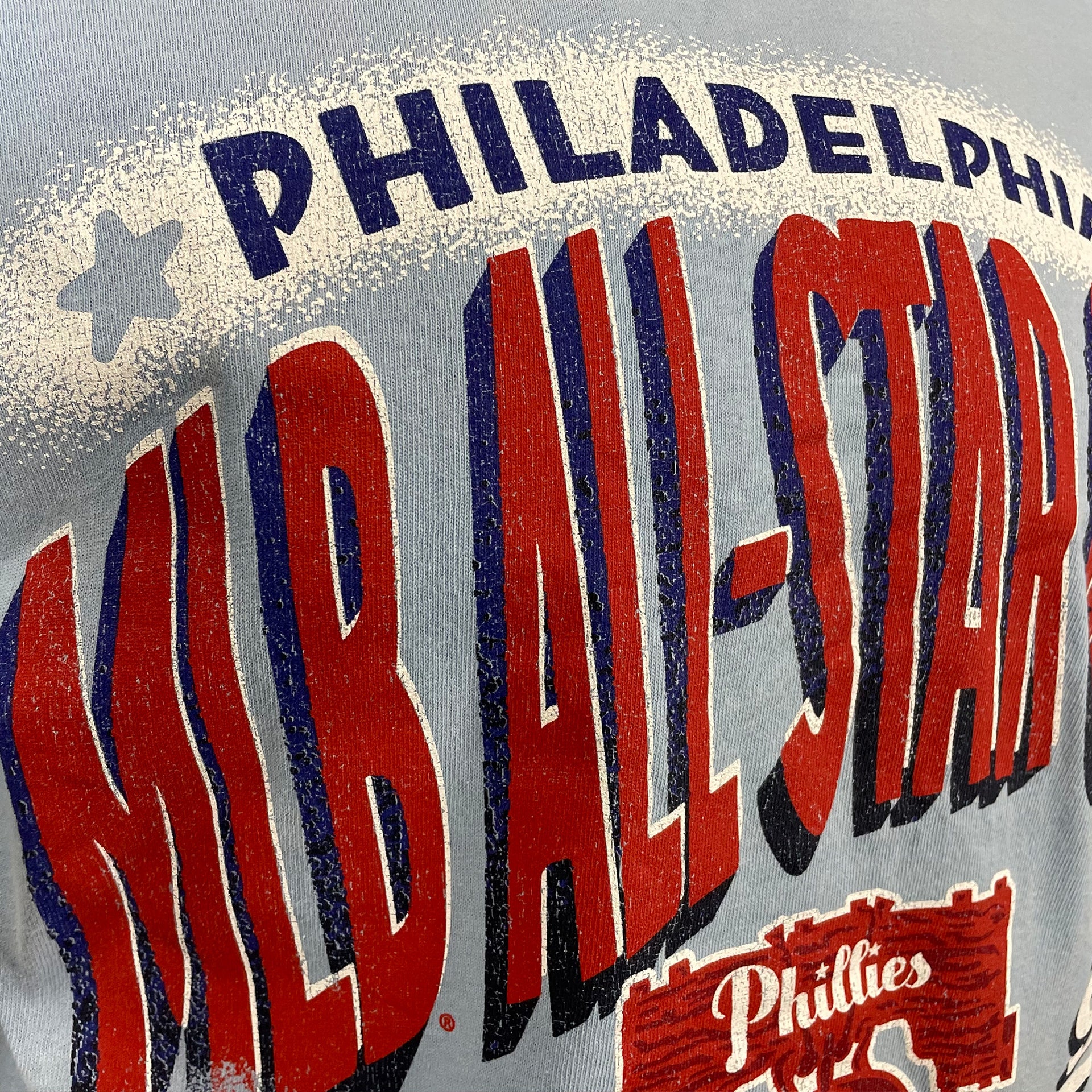 Close up of the MLB All Star lettering on the Philadelphia Phillies Distressed Cooperstown 1952 All Star Game Shibe Park Logo Sky Blue Vintage Tubular T-Shirt