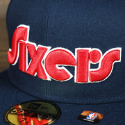 Close up of lettering on the Philadelphia 76ers 2021 Retro Spectrum City Edition Gray Bottom 59Fity Fitted Cap | Navy