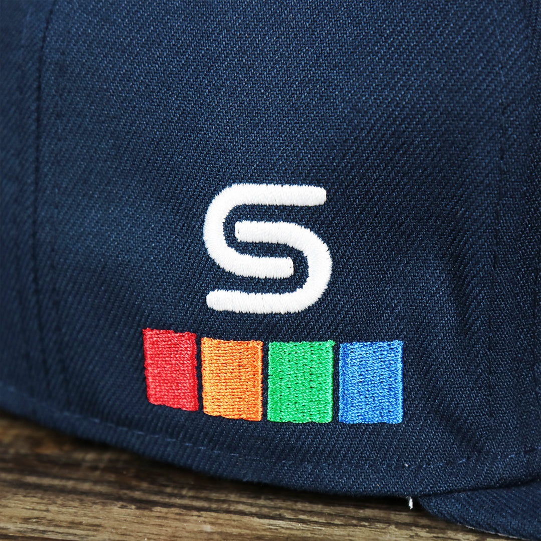 Close up of the spectrum logo on the Philadelphia 76ers 2021 Retro Spectrum City Edition Gray Bottom 59Fity Fitted Cap | Navy